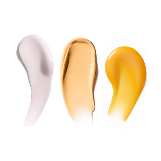 Smears of Strength Trainer Peptide Boost Moisturizer, Banana Bright Vitamin C Serum, and Banana Bright+ Eye Crème shown on a white background. 