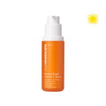 Closed bottle of Banana Bright Vitamin C Serum on a white background. Upper right corner has an icon of a yellow sun.