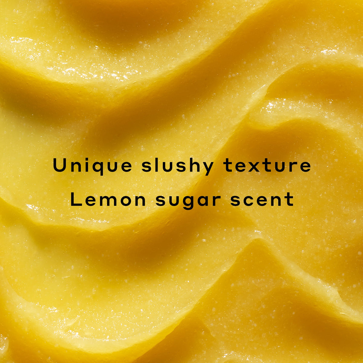 Smear of Lemonade Smoothing Scrub as the background with text laid over: Unique slushy texture, Lemon sugar scent