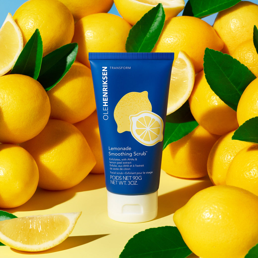 Stylized image of Lemonade Smoothing Scrub against a background of lemons. 